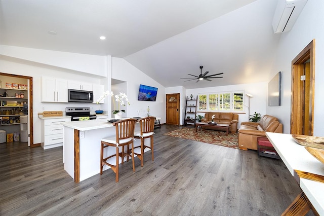 15-2063 18th Ave, Keaau, HI 96749 - kitchen featuring stainless steel microwave, range with electric cooktop, lofted ceiling, white cabinetry, and ceiling fan