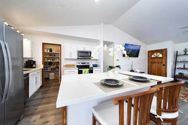15-2063 18th Ave, Keaau, HI 96749 - kitchen with stainless steel appliances, vaulted ceiling, dark wood-style floors, white cabinetry, and a kitchen breakfast bar