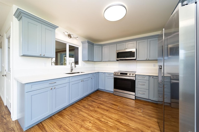 18-4259 Pszyk Rd, Mountain View, HI 96771 - kitchen featuring appliances with stainless steel finishes, a sink, gray cabinets, wood finished floors, and light countertops