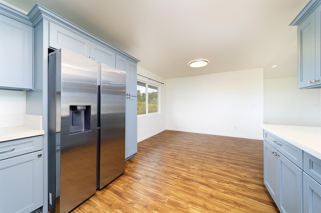 18-4259 Pszyk Rd, Mountain View, HI 96771 - kitchen with stainless steel fridge with ice dispenser, light countertops, light wood finished floors, and baseboards