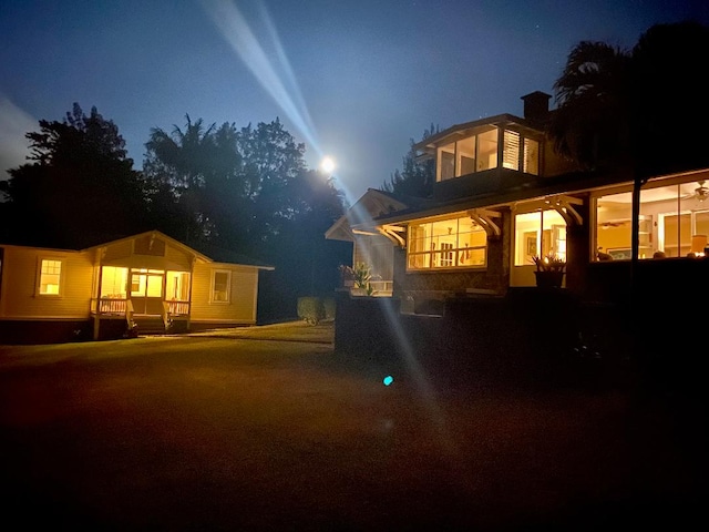 39-3383 Old Mamalahoa Hwy, Ookala, HI 96774 - back of house at night featuring a chimney