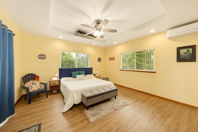 15-1697 7th Ave, Keaau, HI 96749 - bedroom with a raised ceiling, an AC wall unit, light wood-style flooring, recessed lighting, and baseboards