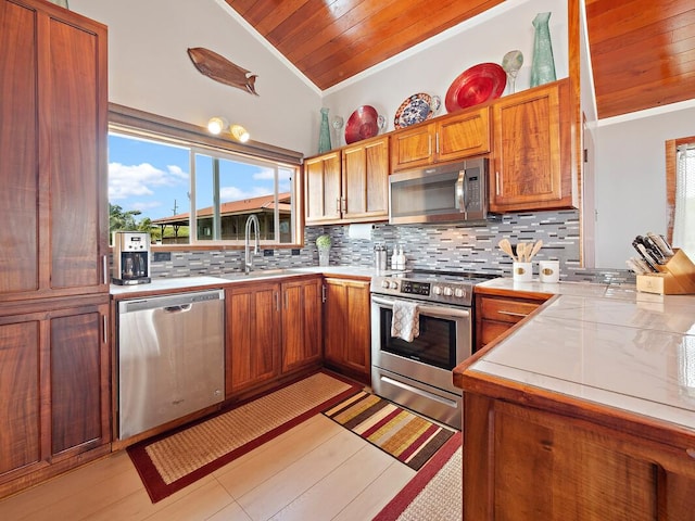 94-6543 Kamaoa Rd, Naalehu, HI 96772 - kitchen with appliances with stainless steel finishes, lofted ceiling, tasteful backsplash, light countertops, and crown molding