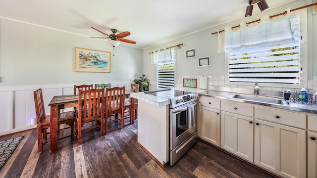 7990 Ulili Rd Unit A, Kekaha, HI 96752 - kitchen featuring stainless steel counters, stainless steel electric range oven, a ceiling fan, dark wood-type flooring, and a peninsula