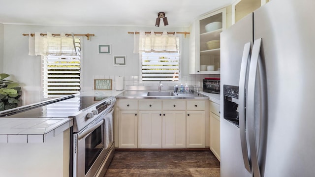 7990 Ulili Rd Unit A, Kekaha, HI 96752 - kitchen with stainless steel appliances, dark wood-style flooring, backsplash, a sink, and glass insert cabinets