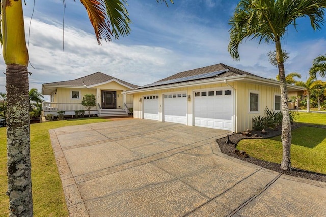 1187 Nohea St, Kalaheo, HI 96741 - single story home with driveway, solar panels, a front yard, and board and batten siding