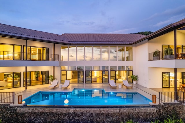 76-981 Aeo St, Kailua-Kona, HI 96740 - back of property with a balcony, a patio, an outdoor pool, and stucco siding