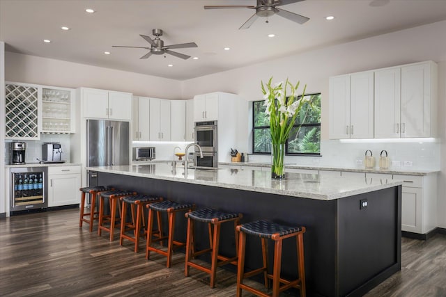 76-981 Aeo St, Kailua-Kona, HI 96740 - kitchen with wine cooler, appliances with stainless steel finishes, ceiling fan, dark wood-style floors, and recessed lighting