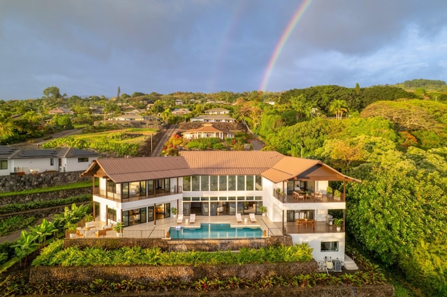 76-981 Aeo St, Kailua-Kona, HI 96740 - back of house featuring a balcony, a patio, an outdoor pool, and outdoor lounge area