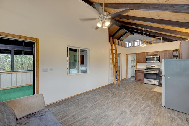 16-2159 Bamboo Dr, Pahoa, HI 96778 - kitchen featuring appliances with stainless steel finishes, a ceiling fan, brown cabinets, beamed ceiling, and light wood-type flooring
