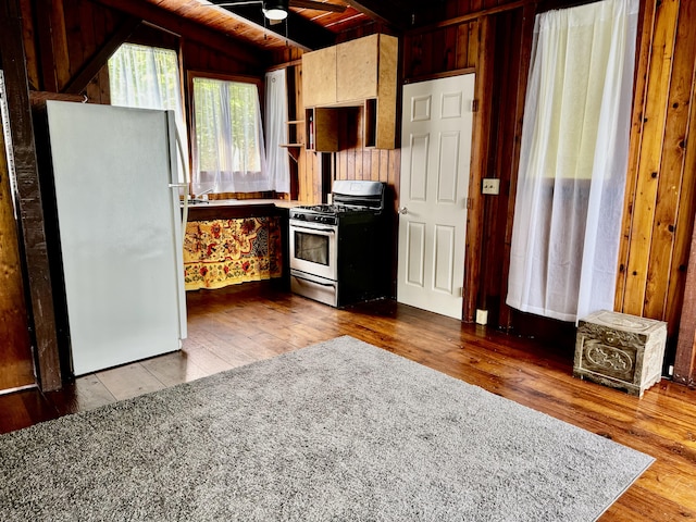 13-1382 Pueo St, Pahoa, HI 96778 - kitchen with stainless steel gas range oven, freestanding refrigerator, hardwood / wood-style floors, wood walls, and ceiling fan