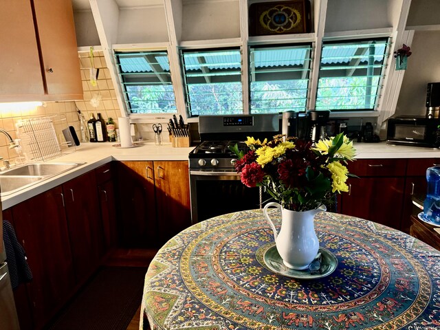 13-1382 Pueo St, Pahoa, HI 96778 - kitchen featuring gas stove, light countertops, a sink, and backsplash