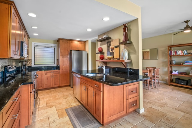 2370 Hoohu Rd Unit 712, Koloa, HI 96756 - kitchen featuring a sink, appliances with stainless steel finishes, stone tile floors, dark stone countertops, and brown cabinetry