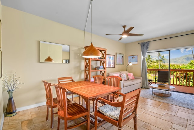 2370 Hoohu Rd Unit 712, Koloa, HI 96756 - dining area with ceiling fan, stone tile flooring, and baseboards