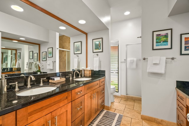 2370 Hoohu Rd Unit 712, Koloa, HI 96756 - bathroom featuring toilet, a stall shower, double vanity, baseboards, and recessed lighting