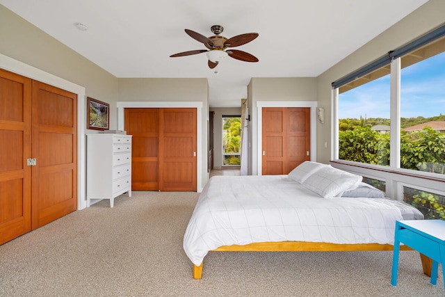 1165 Milia St, Kalaheo, HI 96741 - bedroom featuring two closets, light colored carpet, and a ceiling fan