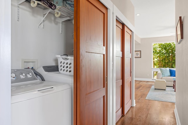 1165 Milia St, Kalaheo, HI 96741 - washroom featuring light wood-style flooring, washing machine and dryer, and baseboards