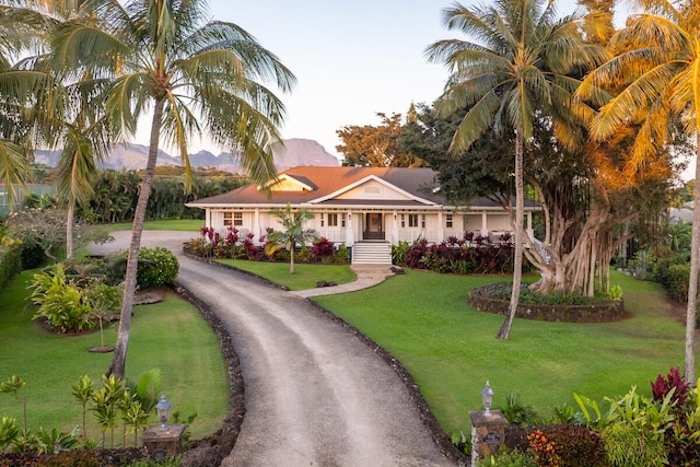 3042 Lauae Pl, Koloa, HI 96756 - view of front of property featuring asphalt driveway, a front lawn, a mountain view, and covered porch