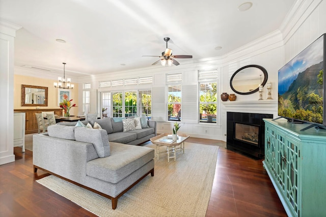 3042 Lauae Pl, Koloa, HI 96756 - living area featuring a decorative wall, a tiled fireplace, ceiling fan, dark wood-style flooring, and a chandelier