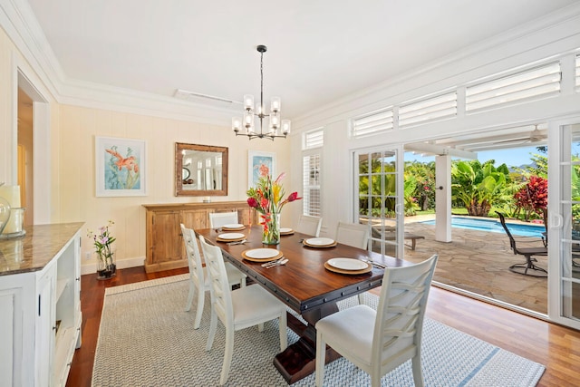 3042 Lauae Pl, Koloa, HI 96756 - dining room featuring ornamental molding, wood finished floors, plenty of natural light, and a chandelier