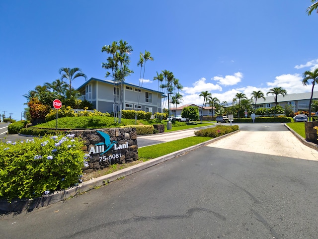 75-6081 Alii Dr Unit D104, Kailua-Kona, HI 96740 - view of asphalt street featuring traffic signs, a residential view, and curbs