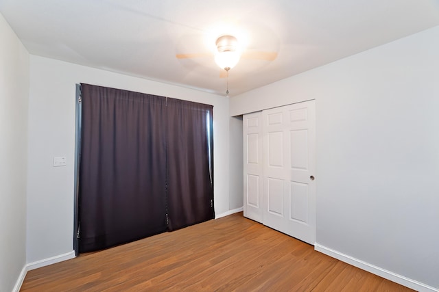 75-6081 Alii Dr Unit D104, Kailua-Kona, HI 96740 - unfurnished bedroom featuring wood finished floors, baseboards, a closet, and ceiling fan