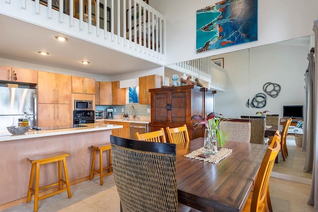 3880 Wyllie Rd Unit 12B, Princeville, HI 96722 - dining room with a towering ceiling and light tile patterned floors