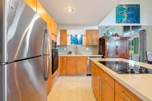 3880 Wyllie Rd Unit 12B, Princeville, HI 96722 - kitchen with black appliances, a sink, light countertops, and backsplash