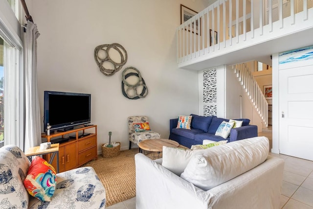 3880 Wyllie Rd Unit 12B, Princeville, HI 96722 - living room featuring stairs, light tile patterned flooring, and a towering ceiling