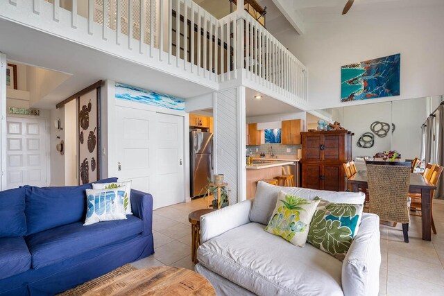 3880 Wyllie Rd Unit 12B, Princeville, HI 96722 - living room with light tile patterned floors, a high ceiling, and beamed ceiling