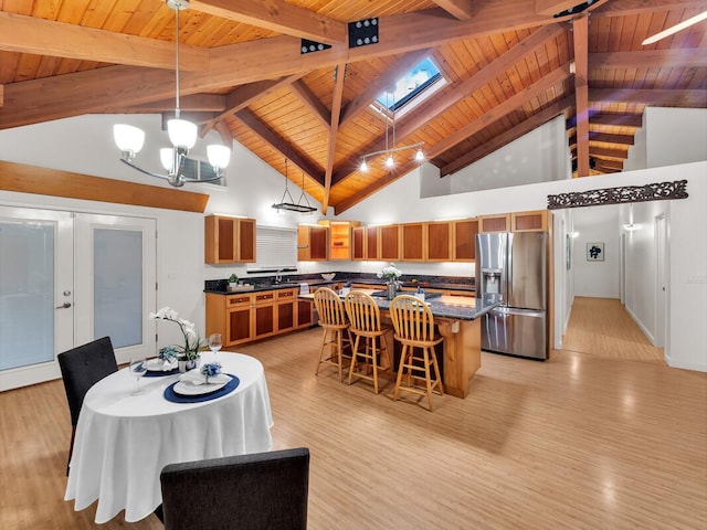 15-1545 27th Ave, Keaau, HI 96749 - dining area featuring wooden ceiling with exposed beams, a skylight, light wood-style flooring, high vaulted ceiling, and french doors
