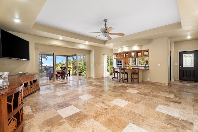 74-4967 Kiwi St, Kailua-Kona, HI 96740 - living room featuring baseboards, plenty of natural light, light stone finish floors, ceiling fan, and recessed lighting