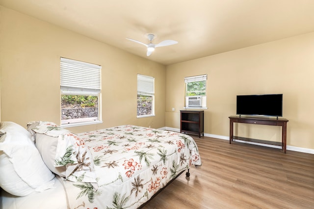 74-4967 Kiwi St, Kailua-Kona, HI 96740 - bedroom with wood finished floors, baseboards, cooling unit, and a ceiling fan