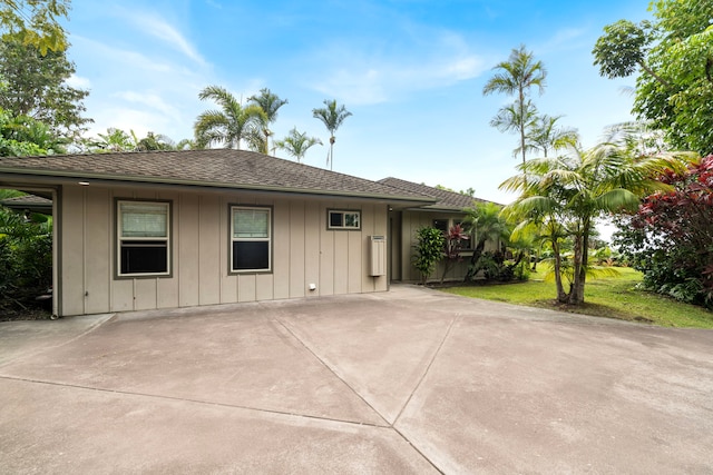74-4967 Kiwi St, Kailua-Kona, HI 96740 - view of front of house featuring board and batten siding, concrete driveway, and roof with shingles
