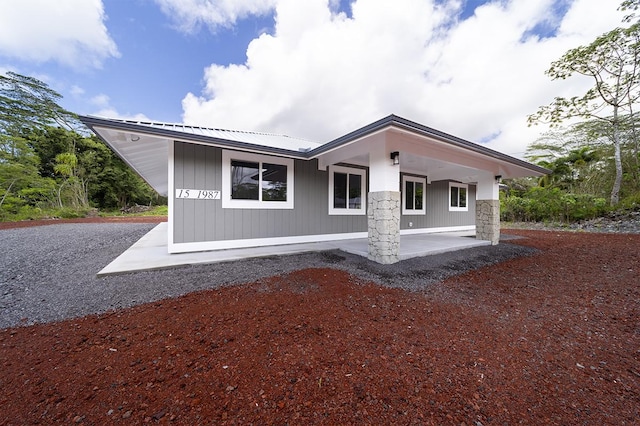 15-1987 27th Ave, Keaau, HI 96749 - rear view of property featuring a metal roof and a patio area