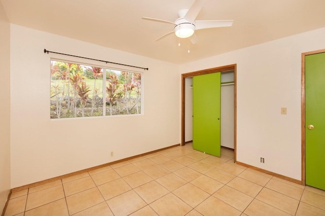 73-1361 Kaukahoku Rd, Kailua-Kona, HI 96740 - unfurnished bedroom with baseboards, light tile patterned floors, a closet, and ceiling fan