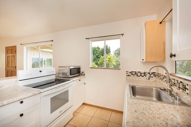73-1361 Kaukahoku Rd, Kailua-Kona, HI 96740 - kitchen with white range with electric cooktop, stainless steel microwave, a sink, baseboards, and light tile patterned floors
