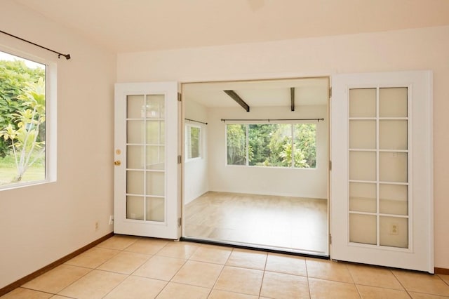 73-1361 Kaukahoku Rd, Kailua-Kona, HI 96740 - empty room with light tile patterned floors, baseboards, and beamed ceiling