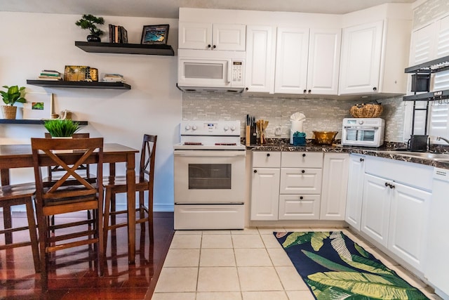 75-5766 Kuakini Hwy Unit 207, Kailua-Kona, HI 96740 - kitchen featuring white appliances, tasteful backsplash, and white cabinets