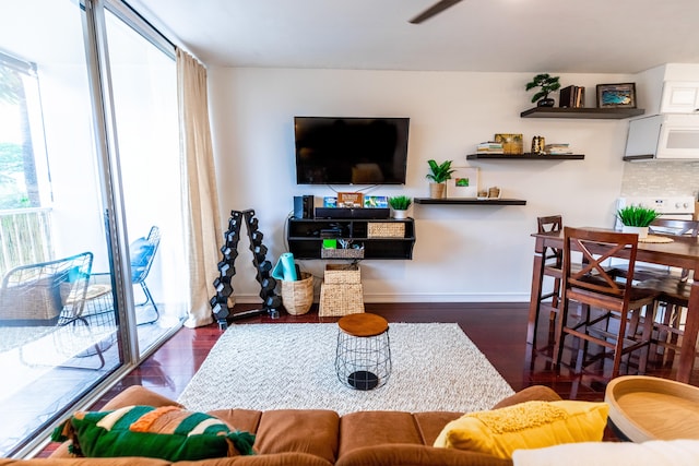 75-5766 Kuakini Hwy Unit 207, Kailua-Kona, HI 96740 - living area with plenty of natural light, wood finished floors, a ceiling fan, and baseboards