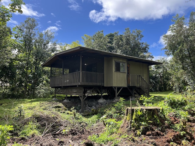 15-2025 20th Ave, Keaau, HI 96749 - view of front facade with a sunroom, a deck, and stairs