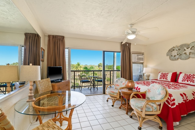 5061 Lawai Rd Unit 333, Koloa, HI 96756 - bedroom featuring multiple windows, access to exterior, a textured ceiling, a wall mounted air conditioner, and light tile patterned floors