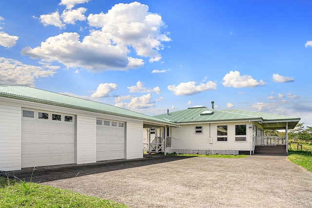 28-811 Akaka Falls Rd, Honomu, HI 96728 - view of front facade with asphalt driveway, an attached garage, and metal roof