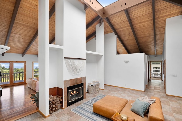 28-811 Akaka Falls Rd, Honomu, HI 96728 - living area featuring wood ceiling with exposed beams, a fireplace, baseboards, and high vaulted ceiling