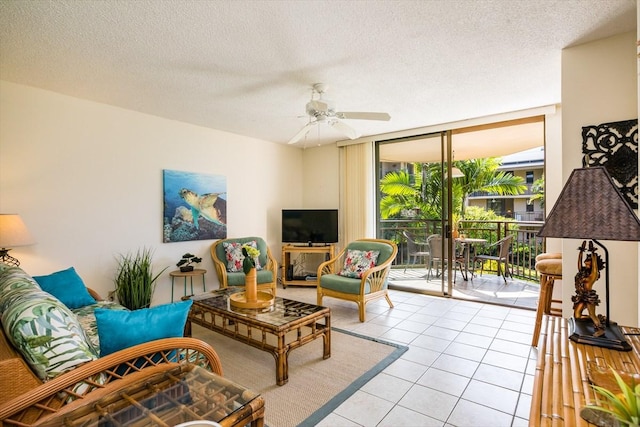 75-6026 Alii Dr Unit 5207, Kailua-Kona, HI 96740 - living room featuring light tile patterned flooring, ceiling fan, a textured ceiling, and floor to ceiling windows