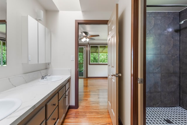 4085-B Noho Rd, Koloa, HI 96756 - full bath with double vanity, a tile shower, ceiling fan, wood finished floors, and baseboards