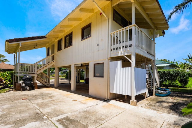 4085-B Noho Rd, Koloa, HI 96756 - view of property exterior with stairs, a carport, driveway, and a balcony