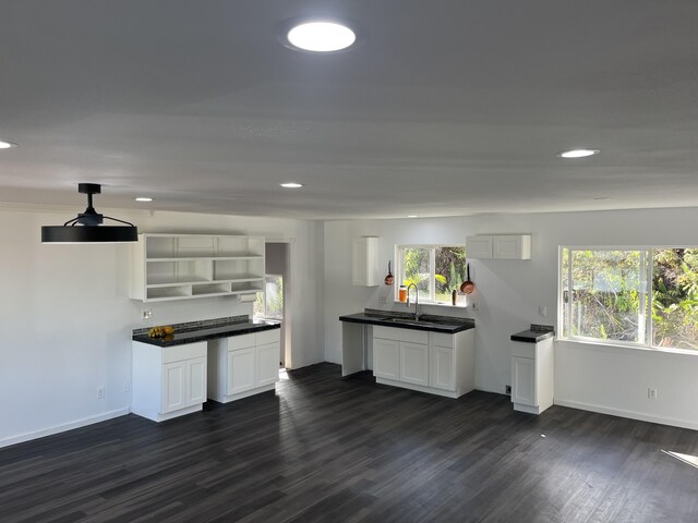 16-2064 Azure Dr, Pahoa, HI 96778 - kitchen featuring dark wood finished floors, open shelves, dark countertops, a sink, and baseboards