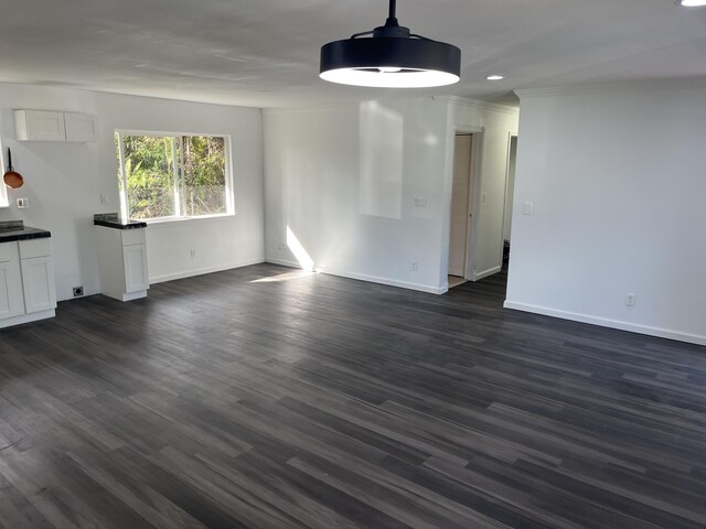 16-2064 Azure Dr, Pahoa, HI 96778 - unfurnished dining area featuring baseboards, dark wood-type flooring, ornamental molding, and recessed lighting