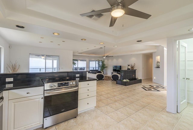 77-6470 Ono Rd, Kailua-Kona, HI 96740 - kitchen with stainless steel range with electric cooktop, a tray ceiling, dark countertops, open floor plan, and white cabinets